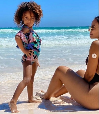 Candace posing like a model at the beach with her mommy.
